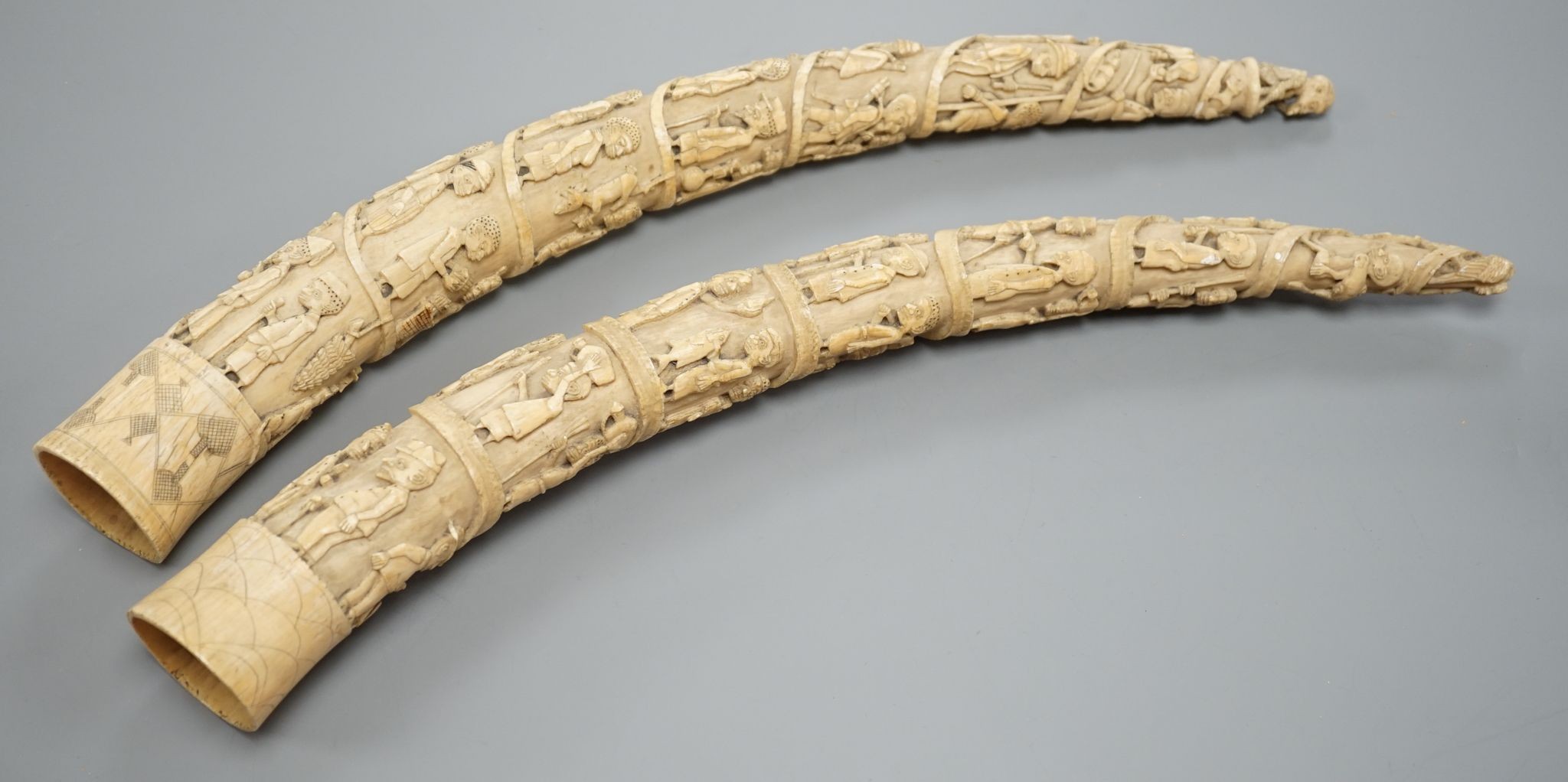 Two Loango carved ivory tusks, Republic of Congo, mid to late 19th century, 46cms long.